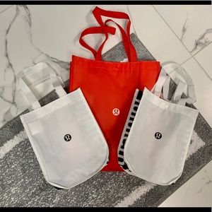 Lululemon tote bags. One large, two small. New. Red/white & black/white.